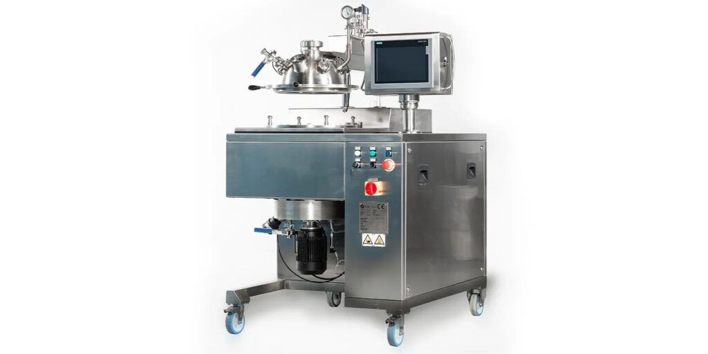 Cosmetic ProcessingLaboratory applications. A stainless steel industrial mixing machine with control buttons, a digital screen, gauges, wiring, and tanks and vessels on wheels, designed for use in laboratories or food and pharmaceutical manufacturing environments.
